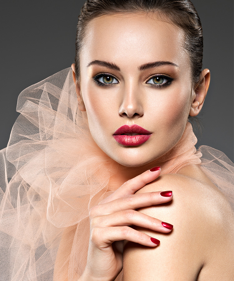 Fashion woman with stylish makeup and red nails